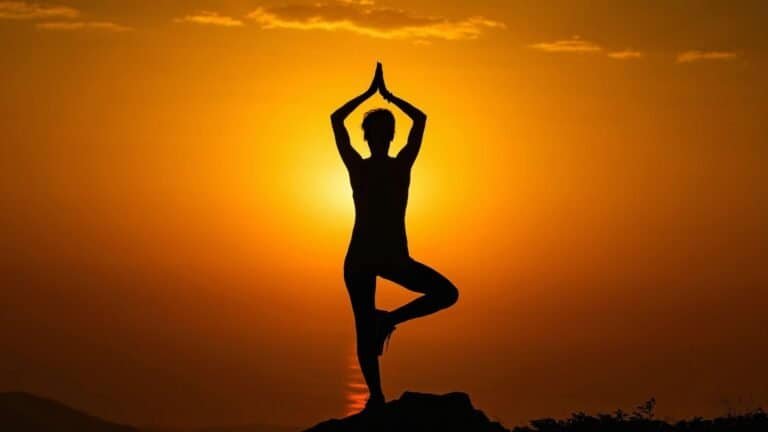 Person practicing yoga at sunset