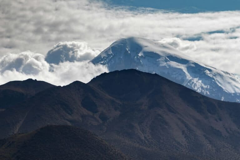 Snow-capped volcano rising over the Altiplano in Bolivia