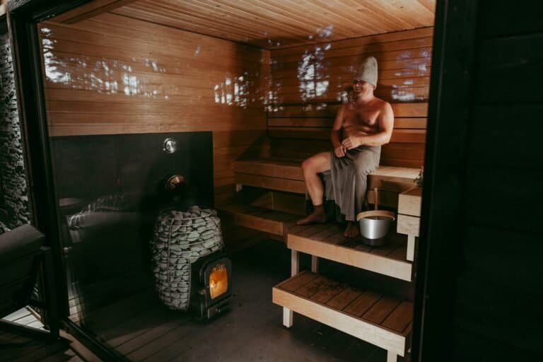 Finland Travelguide. A man relaxing in a traditional Finnish wood-fired sauna
