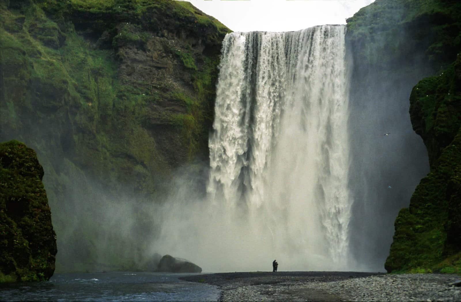 Skogafoss waterfall on Iceland's south coast, with spray rising from the base