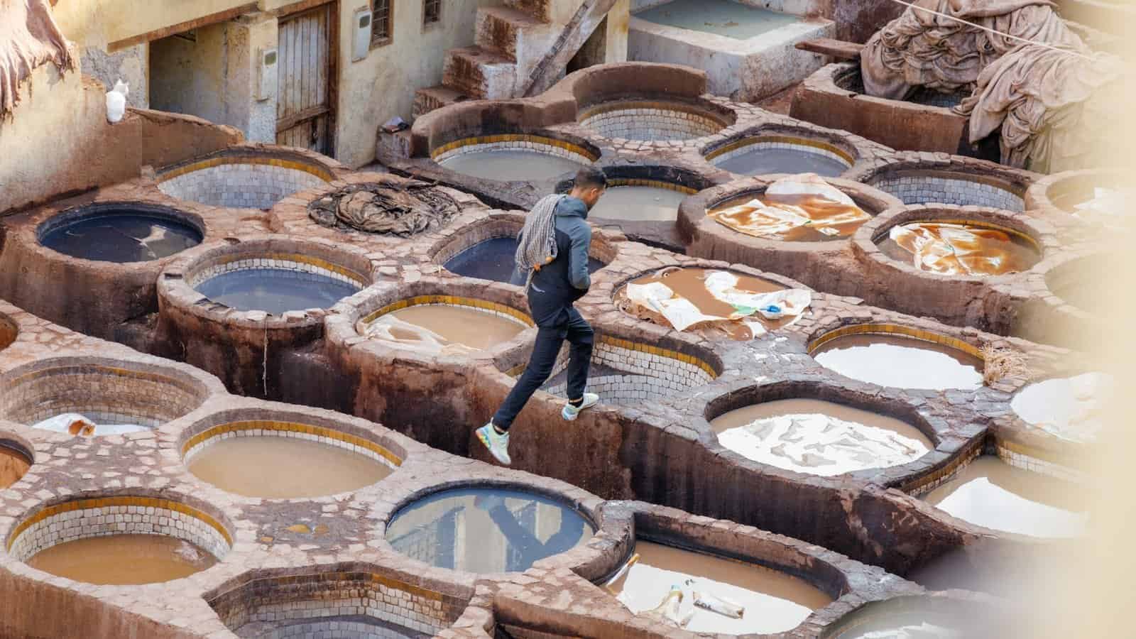 A worker moving across the dye pits of the tanneries in Fez, Morocco