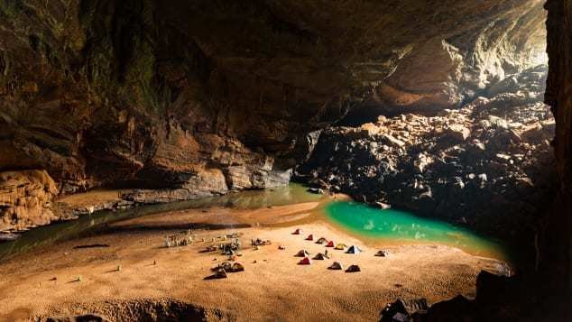 Tents pitched on sand beside an underground lake inside Son Doong cave, Vietnam